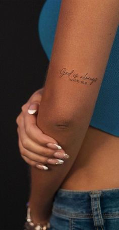 a woman's arm with a tattoo that reads, god is always in my heart