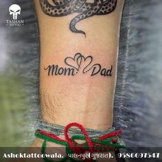 a man with a tattoo on his arm that says mom and dad in cursive font