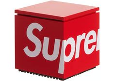 a red box with the word supreme printed on it's front and side panels