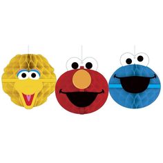 three paper balls with faces and eyes in the shape of sesame, elmo, cookie monster