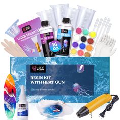 an assortment of crafting supplies including paint, glues and other items in a blue box