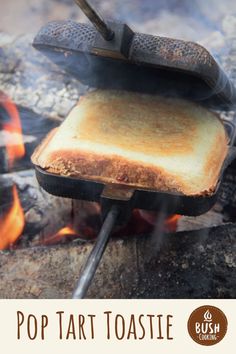 toasted bread cooking over an open fire with the words pop tart toast on it