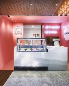 an ice cream shop with pink walls and lights