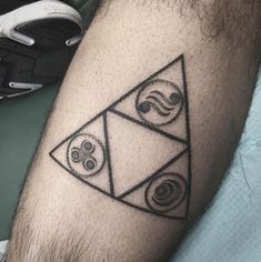 a man's leg with a black and white tattoo design on the side of his arm