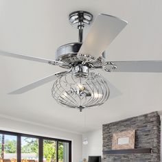 a ceiling fan that is hanging from the ceiling in a living room with a stone fireplace