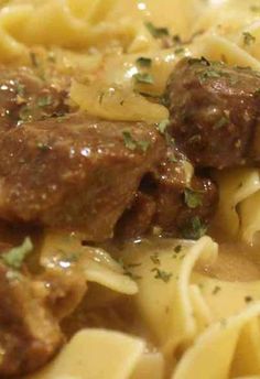 a close up view of some pasta with meatballs and gravy on it