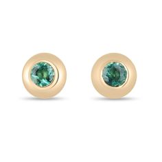 Discover elegance in its simplest form with our Petite Emerald Stud Earrings. These exquisite earrings showcase two enchanting round-cut emeralds, each boasting a captivating medium green hue and a stunning display of luster. Expertly bezel-set in 14k gold, these timeless studs effortlessly elevate any look, making them the perfect addition to your jewelry collection. Setting Style: Bezel Setting Material: 14K Yellow Gold  Main Stone: Emerald Shape: Round Cut  Weight: 0.40-Carats (Total) Dimensions: 3.5mm  Clarity: Semi-Transparent  Color: Green Luster: Very Good Treatments: Natural, Oiling Origin: Zambia  Estimated Retail Value: $1,490.00 USD A certificate of appraisal is provided upon purchase. Keep in mind we custom create all of the items listed here. If you have a special request for Green Single Round Earring, Green 14k Gold Earrings With Bezel Setting, Green Gemstone Oval Cabochon Earrings, Green Cabochon Round Earrings, Emerald Cut Stud Earrings, Fine Jewelry Emerald Earrings, Round Shape, Emerald Stud Earrings, Rose Gold Earrings Studs, Emerald Earrings Studs