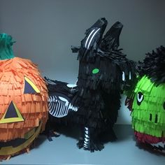 three paper pumpkins decorated to look like witches