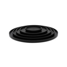 four black plates stacked on top of each other in the shape of a spiral design