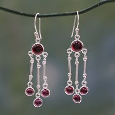 Garnet dances on silver pendulums in mesmerizing earrings from Neeru Goel. The stone of love and passion the scarlet gem is radiant in this flirtatious and graceful earring design. .925 Sterling silver Sterling Silver Chandelier Earrings For Celebration, Anniversary Chandelier Earrings With Long Drop, Anniversary Long Drop Chandelier Earrings, Sterling Silver Chandelier Earrings With Dangling Beads, Elegant Sterling Silver Crystal Earrings With Dangling Beads, Elegant Round Crystal Earrings With Dangling Beads, Elegant Sterling Silver Chandelier Earrings For Celebration, Red Dangle Chandelier Earrings For Anniversary, Sterling Silver Earrings With Dangling Beads