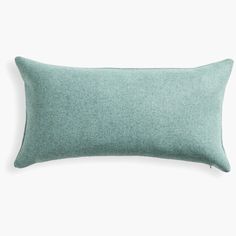 a light green pillow on a white background