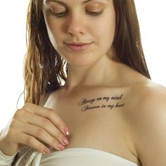 a woman with a tattoo on her chest that says always on my mind someone is my heart