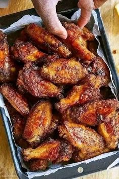 a tray filled with fried bananas on top of a wooden table