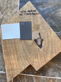 a piece of wood sitting on top of a table next to a paint swatch