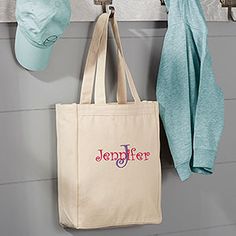 a tote bag hanging on the wall next to a hat rack and coat rack