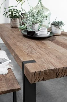 a wooden table with some plants on it