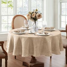 a dining room table set with place settings