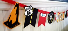 this is an image of a birthday banner with cars and road signs hanging from the wall