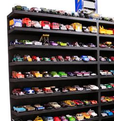 there are many toy cars on the shelves