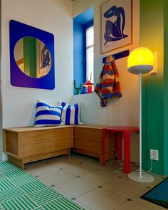 a brightly colored room with blue, green and yellow accents on the walls is shown