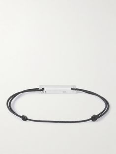 Le Gramme's minimalist pieces are named after their weight in grams, this '1.7g' bracelet is crafted from recycled silver. Made in France, it's threaded on two strands of black punched cord and engraved with the brand's name. Lower Impact Materials. This product is made using at least 50% lower-impact materials or ingredients. Responsible Craftsmanship. This product promotes artisanal skill and brands that invest in communities and adhere to fair-trade principles. Find out more about our Consci… Minimalist Black Sterling Silver Bracelet, Recycled Silver, Cord Bracelets, Latest Fashion, Bracelets For Men, Jewelry Accessories, Jewelry Bracelets, Silver, Black