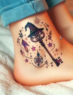 a woman's foot with a tattoo on it that has a key and stars