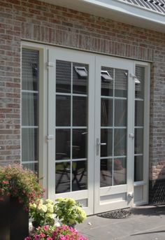 a brick building with white doors and windows