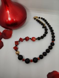 Beautiful handmade necklace with natural red coral cubes(10mm), black agate pearl beads and hematite beads. All metal components are 18K gold plated. The necklace is 47 cm long, is a crew neck and has an adjustable golden steel clasp with a 5 cm extension. The necklace is asymmetrical, very beautiful due to the contrast of the red and black colors and the shape of the beads - cubes and rounds. The necklace is very elegant, very beautiful in summer with a low-cut dress. It recalls the sea, the sun... for those who love nature. A beautiful gift for her All jewels are delivered in a decorated box, ready to be given as a gift to your loved one. How to take care of your jewellery: put on your beauty products (cosmetics, perfumes, ...) before wearing your precious jewel. Clean your jewelry with Elegant Red Beaded Necklace With Black Beads, Elegant Red And Black Beaded Necklaces, Elegant Red And Black Beaded Necklace, Gift Red Coral Necklaces With 8mm Beads, Onyx Beaded Necklaces With 8mm Beads As Gift, Red Onyx Jewelry For Gift, Onyx Beaded Necklaces With Round Beads For Gifts, Onyx Gemstone Beaded Necklaces For Gifts, Onyx Gemstone Beaded Necklaces As Gift