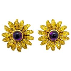 Hello Sunshine!! 18 karat yellow gold Sunflower earrings . Each of the 14 petals have been meticulously set with round brilliant cut Yellow Sapphires. The center of the flower is set with a cabachon Amethyst in a bezel setting. Each earring measures 1.25". The earrings are clip on, but a post can be added. Total Yellow Sapphire weight 10.90 carats Total Amethyst weight 7.60 carats Signed Jean Vitau 18KP Signed Jean Vitau 1994 18K Yellow Gold Round Flower Earrings With Prong Setting, Formal Yellow Gold Flower Earrings With Prong Setting, Formal Yellow Flower-shaped Earrings, Formal Yellow Gold Flower Earrings, Yellow Flower Shaped Jewelry For Formal Occasions, Luxury Yellow Gold Flower Earrings For Formal Occasions, Luxury Yellow Gold Flower Earrings For Formal Events, Vintage Yellow Gold Formal Flower Earrings, Vintage Yellow Gold Flower Earrings For Formal Occasions