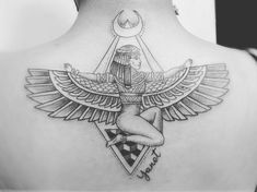 the back of a woman's neck with an egyptian tattoo design on her left shoulder