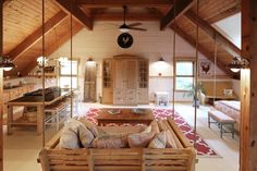 a living room filled with furniture next to a kitchen and dining area in a loft