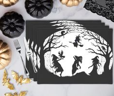 three halloween silhouettes on black paper next to gold stars and pumpkins, with the moon in the background