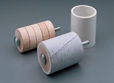 two rolls of toilet paper sitting next to each other on top of a gray surface