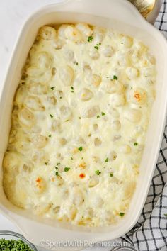 a casserole dish with meat and cheese in it on a checkered cloth