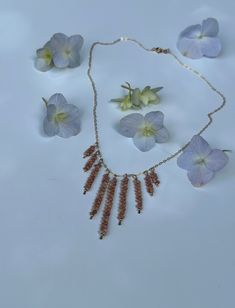 a necklace and earring with flowers on it