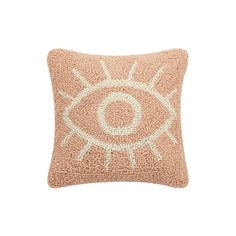 a pink pillow with an eye embroidered on the front and back, sitting on a white background