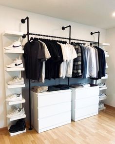 an organized closet with clothes and shoes on the shelves, along with shoe racking