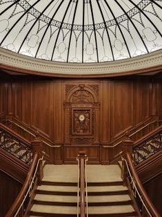 an ornate wooden staircase with glass roof