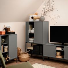 a living room filled with furniture and a flat screen tv on top of a wooden shelf