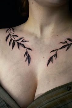 a woman's chest with black leaves on it