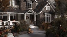 a house with pumpkins on the front porch