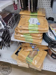 there are many cutting boards stacked on top of each other in this store display case