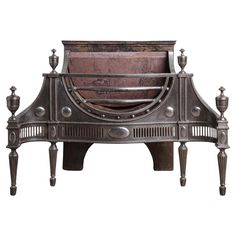 an ornate metal bed frame with two candles on each side and a wooden headboard