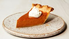 a slice of pumpkin pie with whipped cream on top