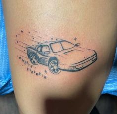 a woman's thigh with a drawing of a car and stars on the side