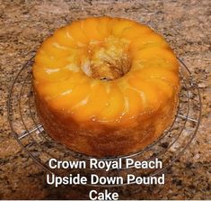 an upside down pound cake sitting on top of a glass plate with the words crown royal peach upside down pound cake