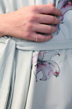 a close up of a person's hand wearing a ring