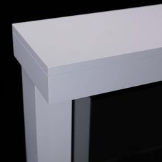 an empty white table against a black background