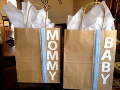 two brown paper bags with the words mommy and baby printed on them