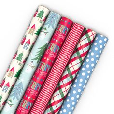 four different colored wrapping paper on top of each other with christmas trees and snowmen